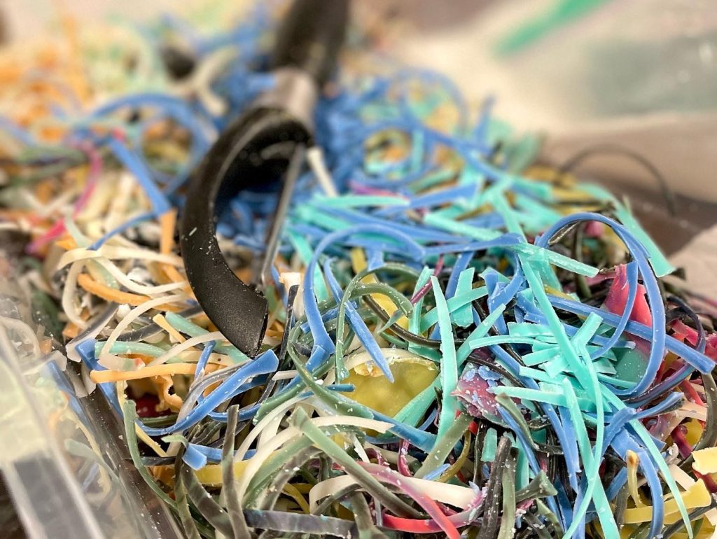 A pile of shredded paper with a pair of scissors.