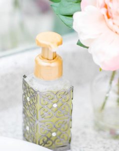 A soap dispenser sitting on top of a counter.