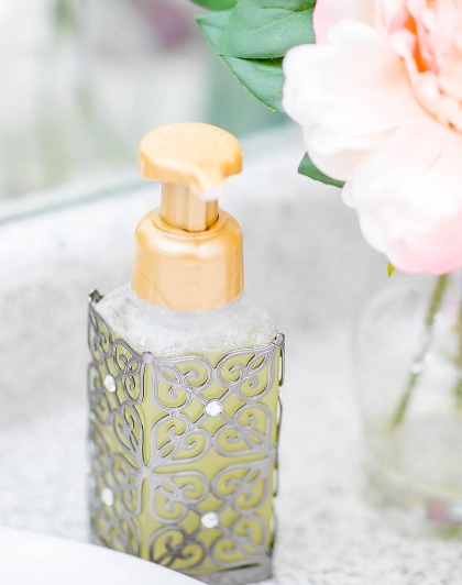 A soap dispenser sitting on top of a counter.