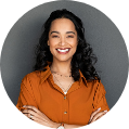 A woman with her arms crossed smiling for the camera.