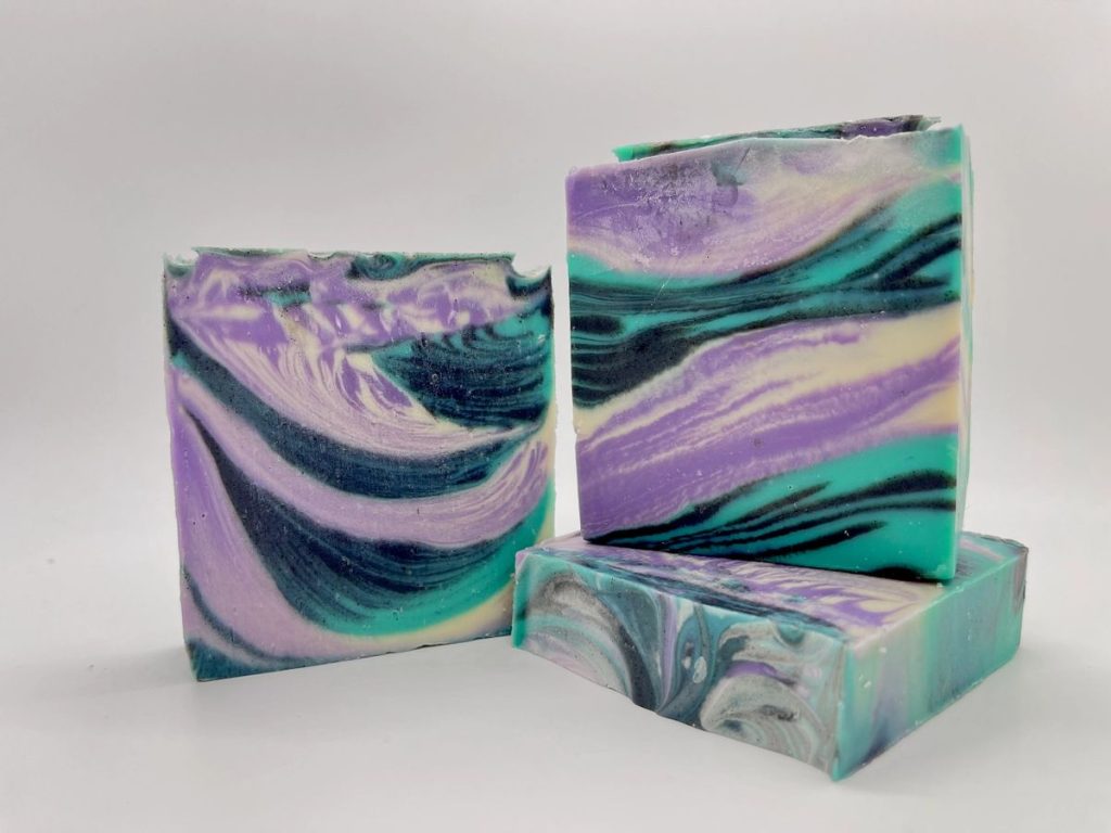 A group of three soap bars sitting on top of each other.