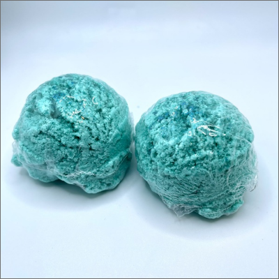 Two blue balls of dough on a white surface.