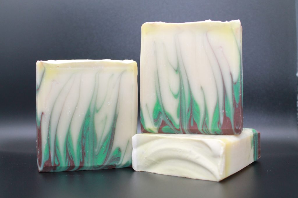 A close up of three soap bars on top of a table.