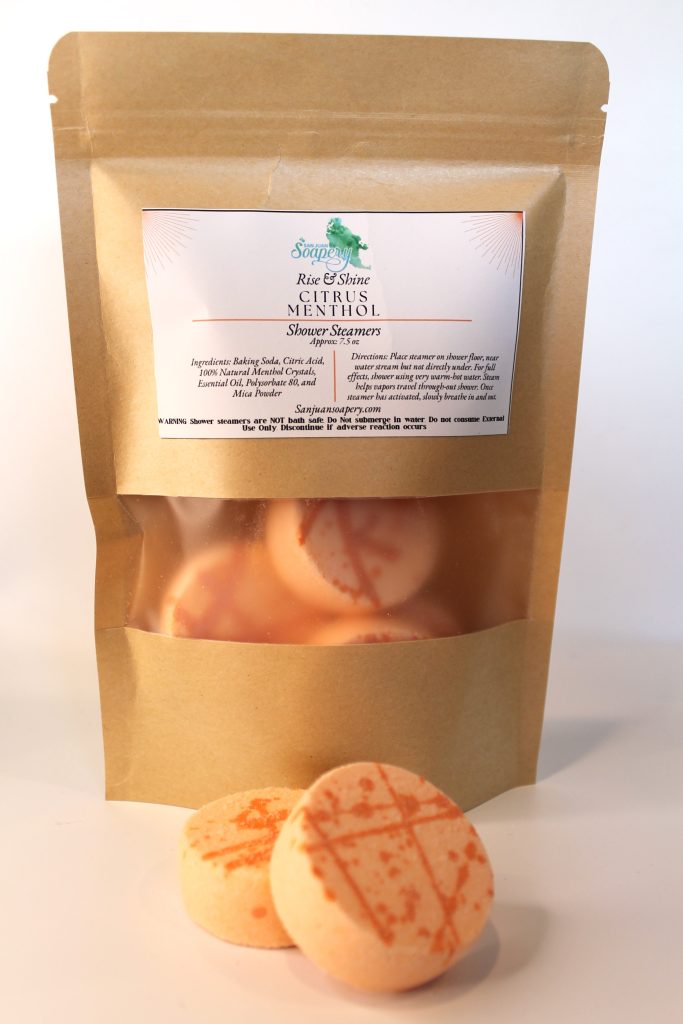 A bag of cookies with orange sugar on top.
