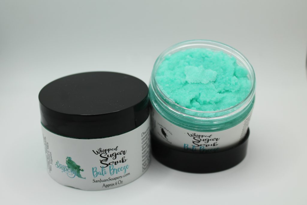 A jar of blue body butter next to another container.