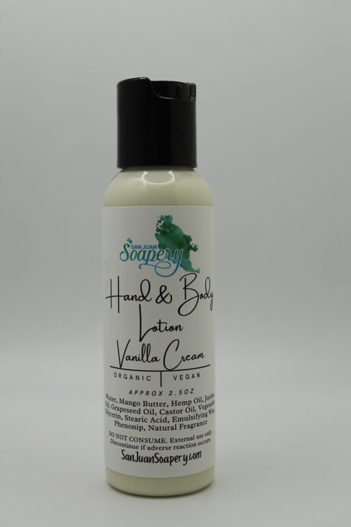 A bottle of lotion with a green leaf on it.