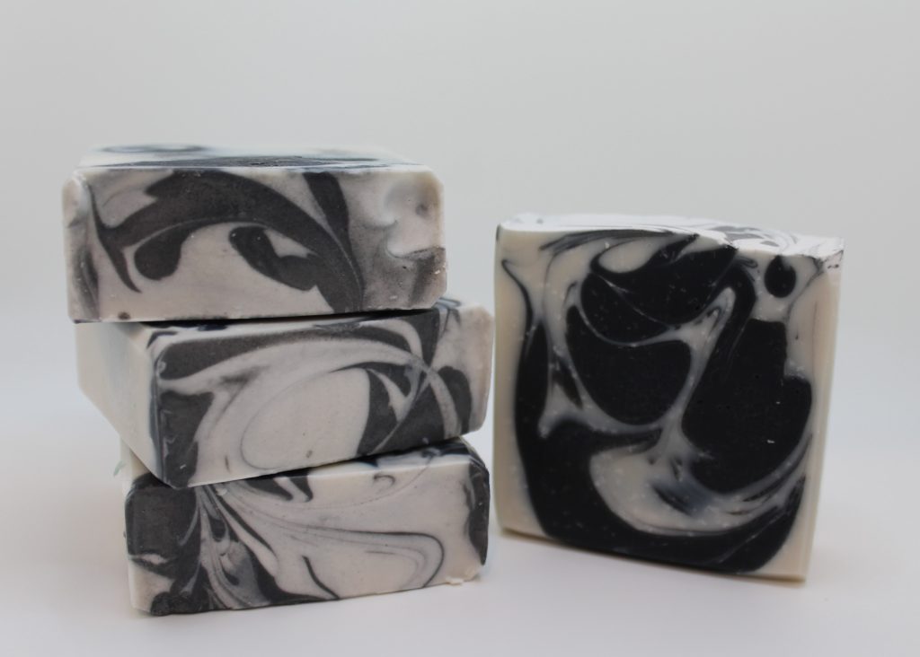 A stack of four black and white soaps.