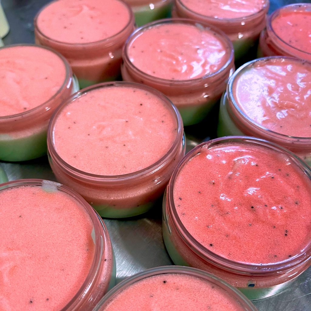 A bunch of jars filled with pink food