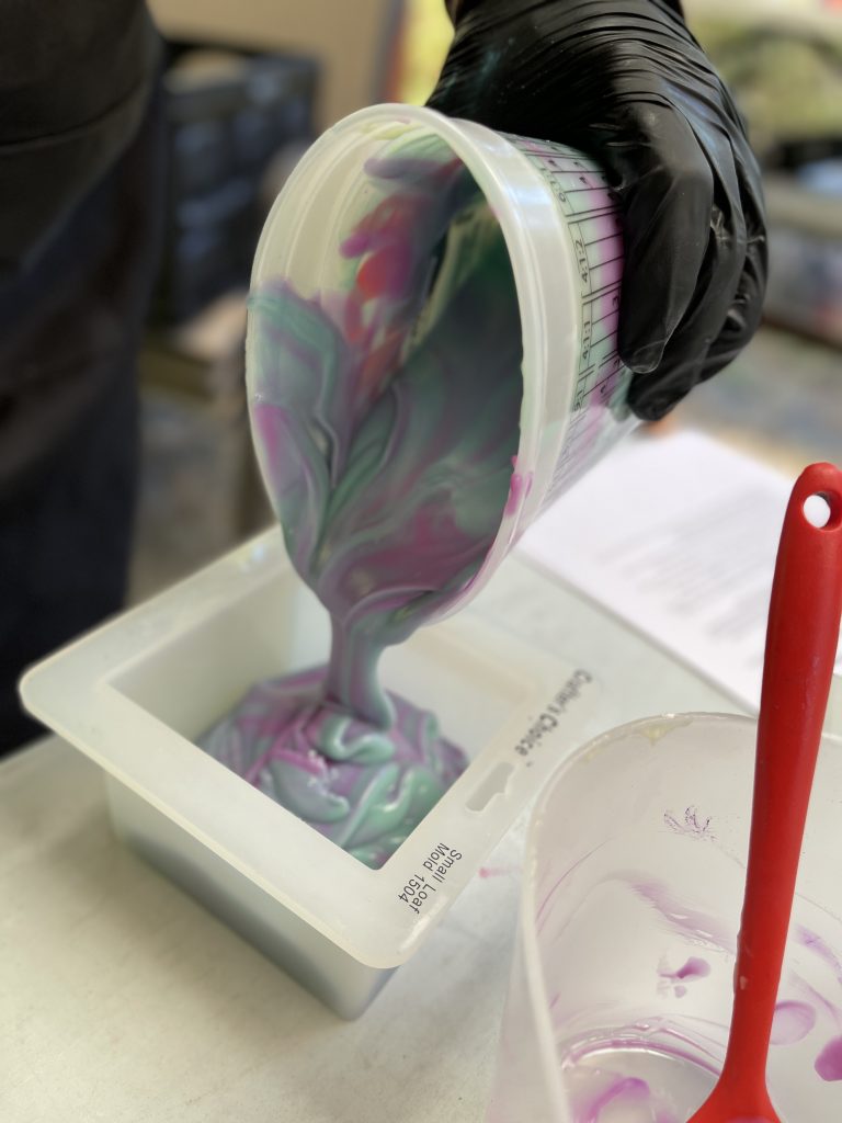 A person pouring liquid into a container.