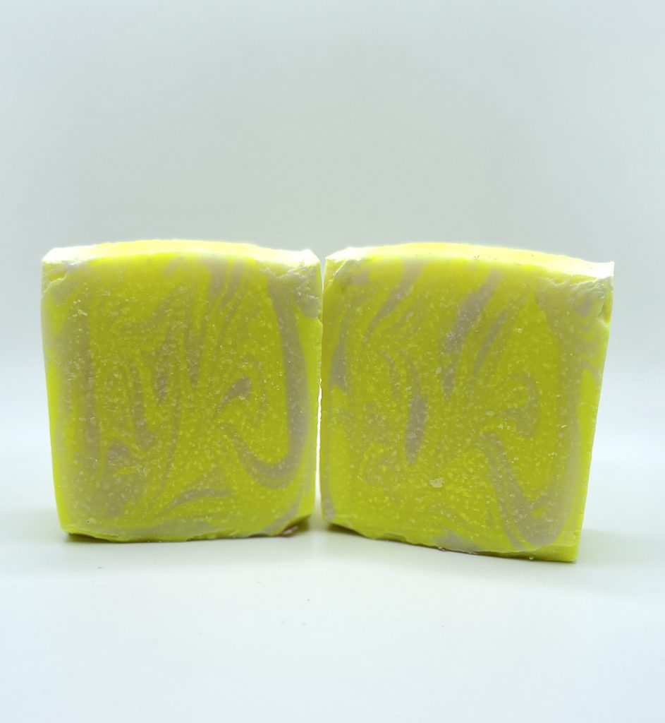 Two yellow soap bars sitting on top of a table.