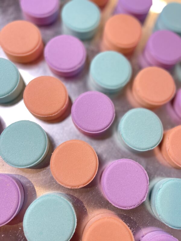 A close up of many different colored pills