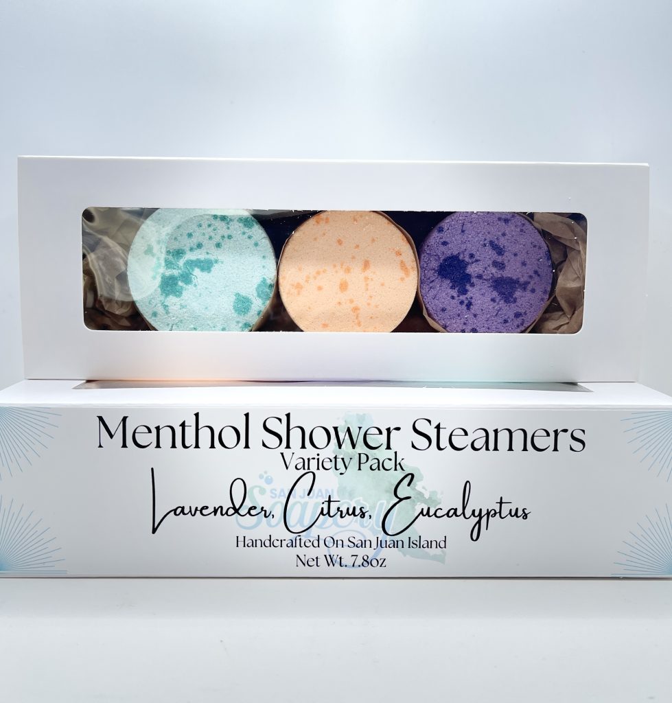 A box of three shower steamers in different colors.