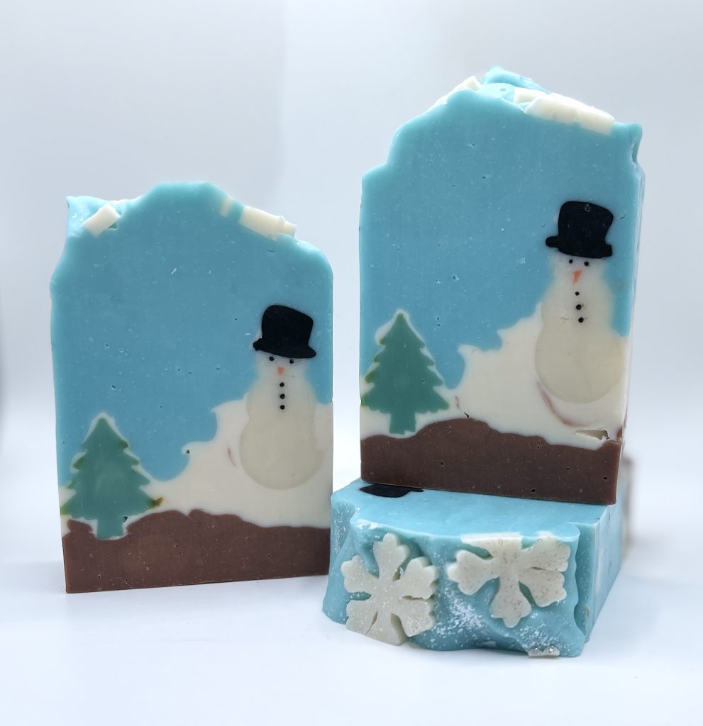 A snowman is shown on the top of a blue block.