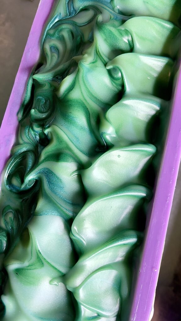 A purple box filled with green and white candy.