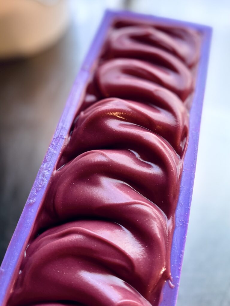 A close up of some red food on top of a purple tray.